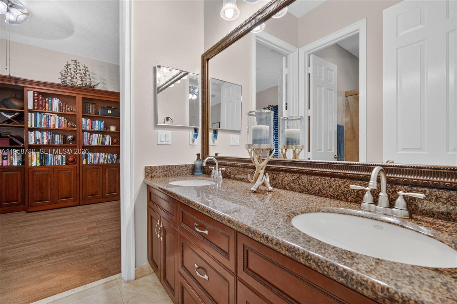 14931 Southwest 38th Street Davie, FL 33331 - Photo 68 of 82 a bathroom with a granite countertop double vanity sink and a mirror