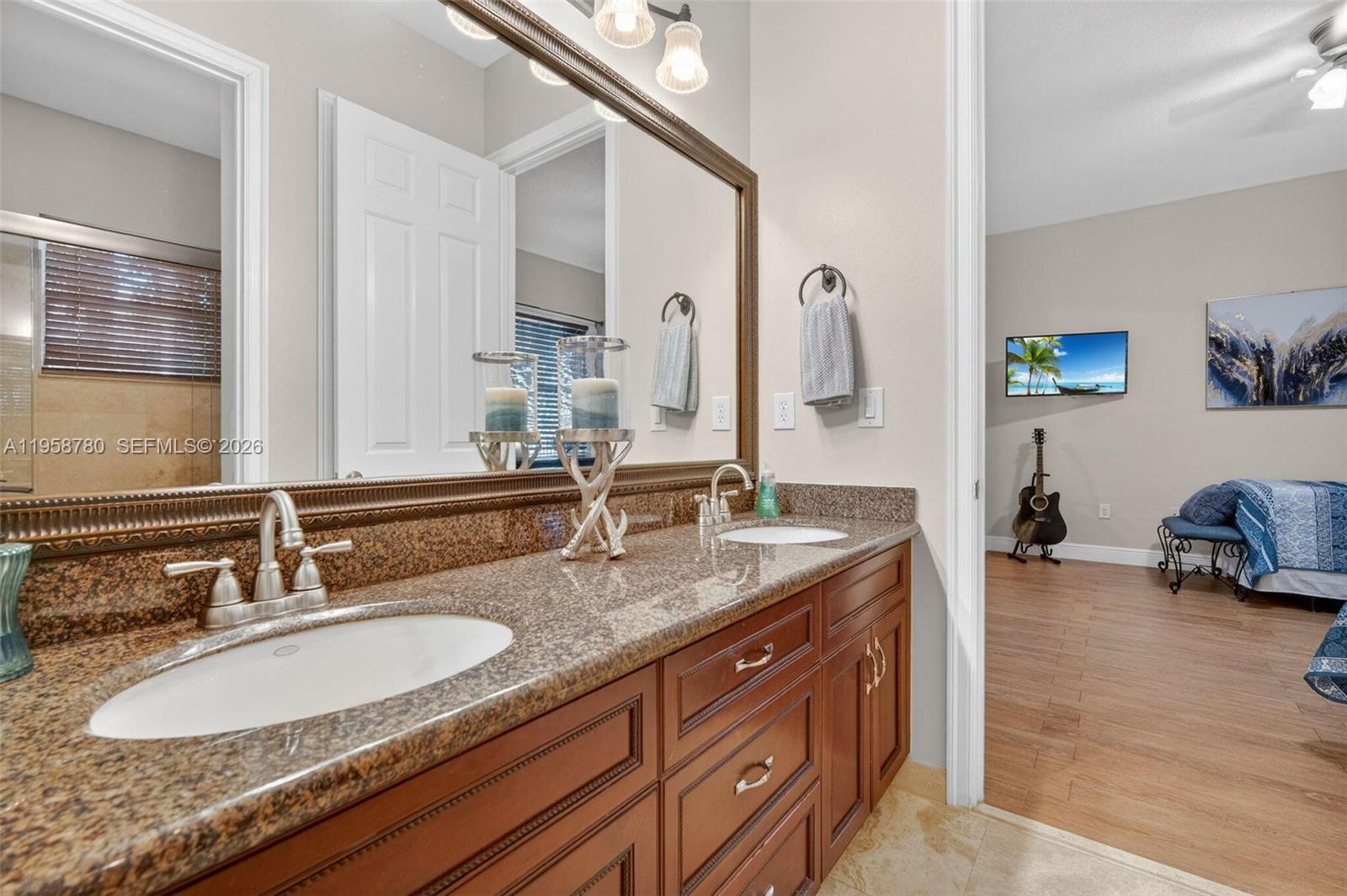 14931 Southwest 38th Street Davie, FL 33331 - Photo 69 of 82 a bathroom with a sink double vanity and a mirror