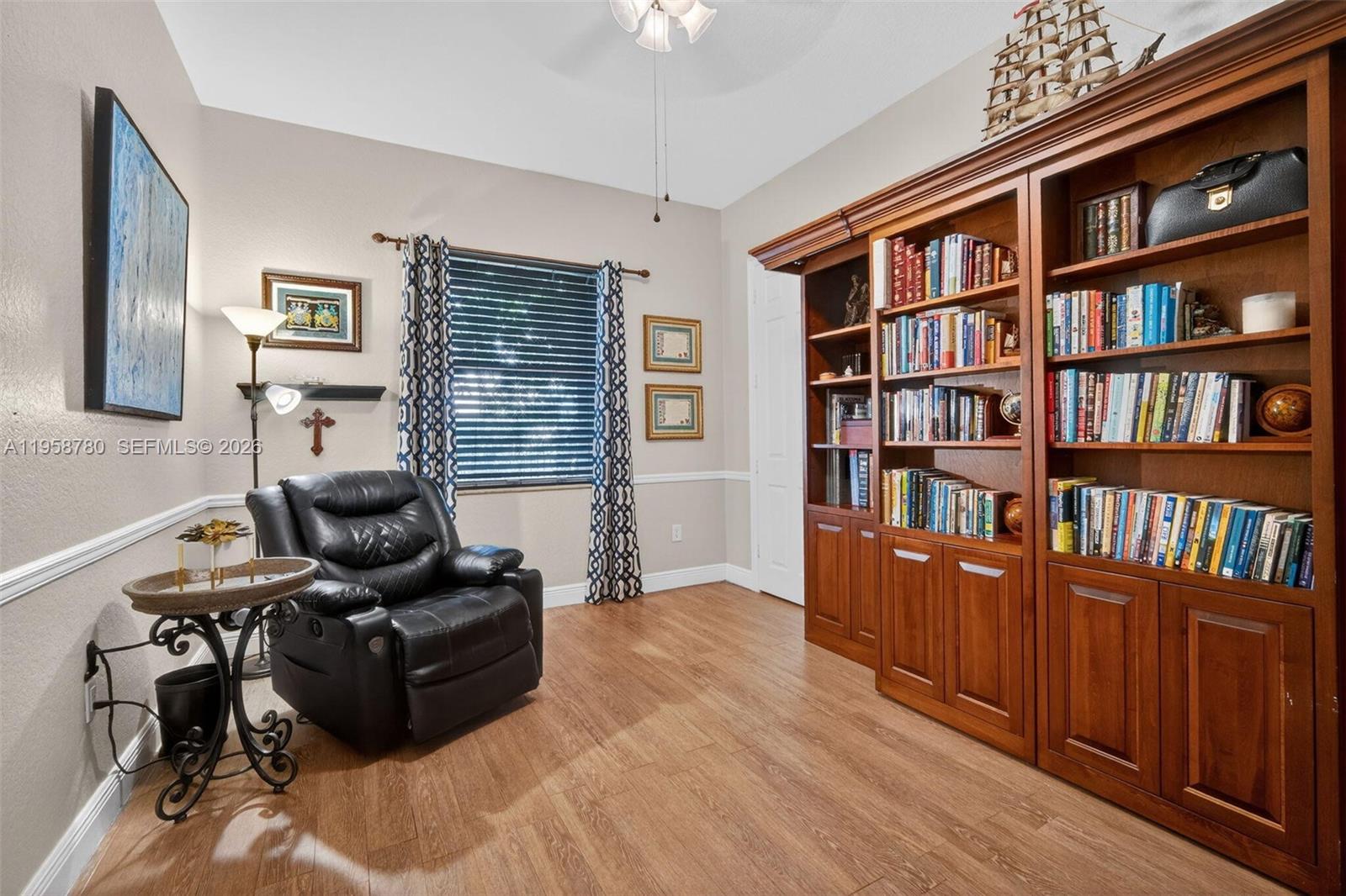 14931 Southwest 38th Street Davie, FL 33331 - Photo 71 of 82 a living room with furniture and a book shelf