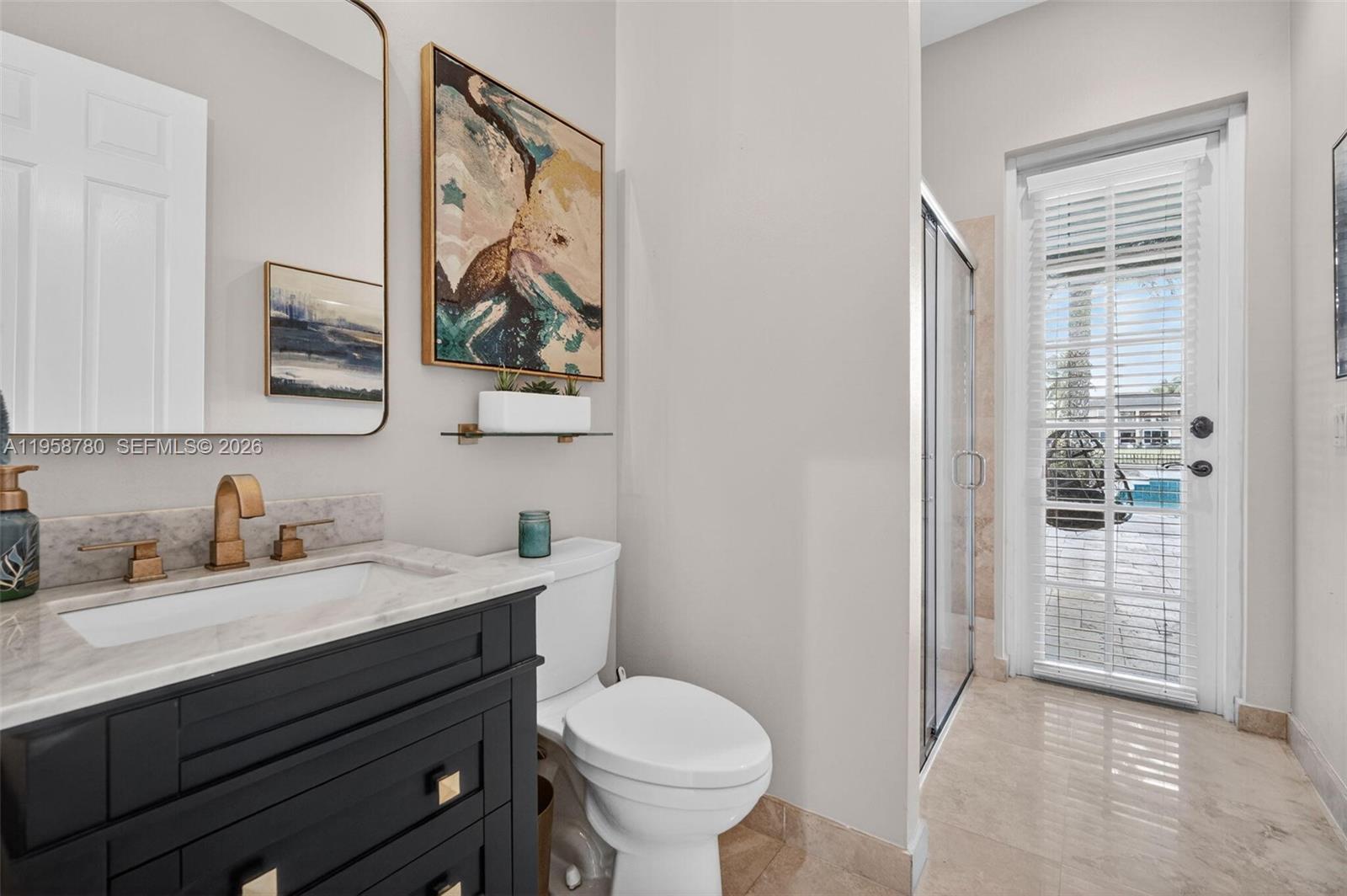 14931 Southwest 38th Street Davie, FL 33331 - Photo 72 of 82 a bathroom with a toilet sink and mirror