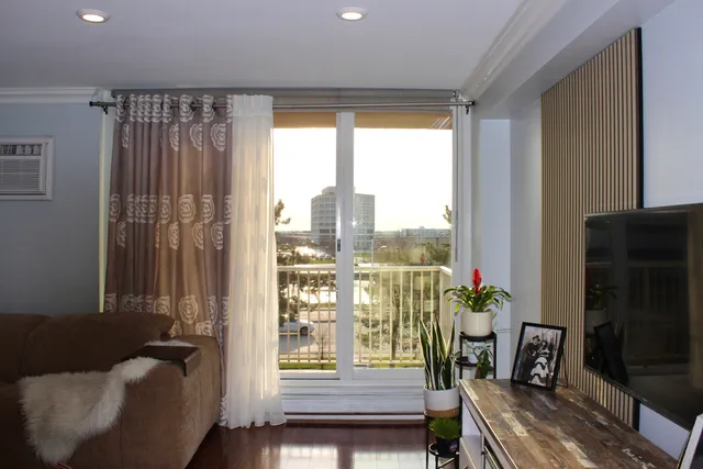 a living room with furniture and a potted plant