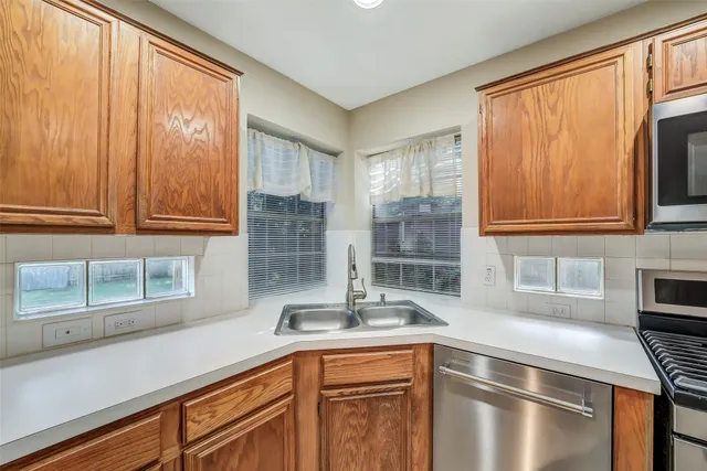 a kitchen with stainless steel appliances a sink and a window