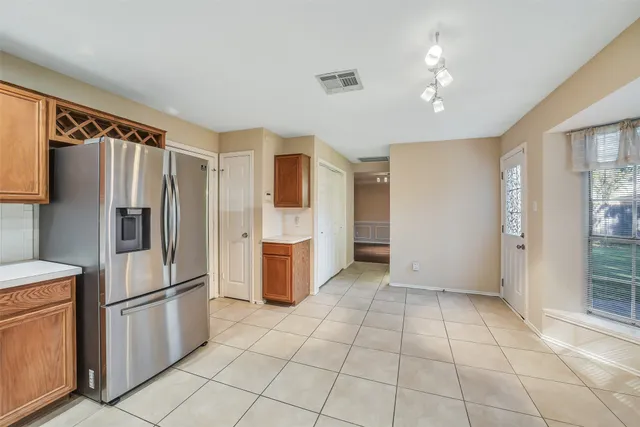 a kitchen with stainless steel appliances a refrigerator and a sink