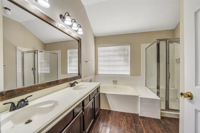 a bathroom with a bathtub and a shower