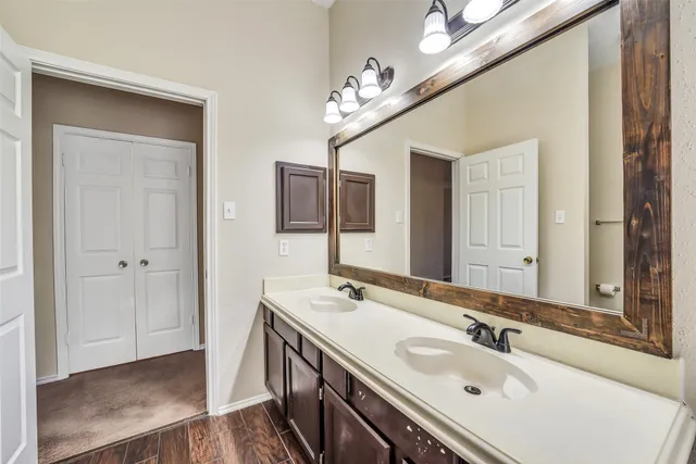 an empty room with windows and chandelier fan