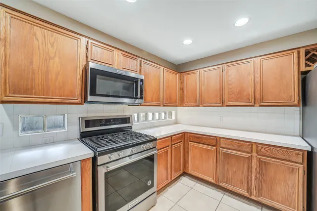 a kitchen with granite countertop cabinets stainless steel appliances and sink