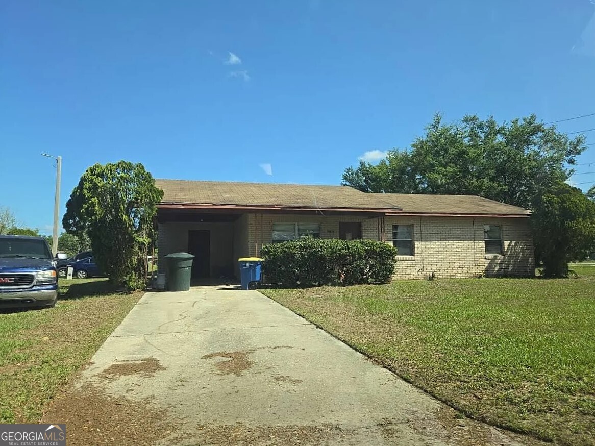 a view of a house with a yard and garage