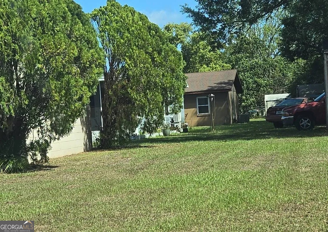 2190 Green Tree Court Bartow, FL 33830 - Photo 2 of 5 a view of a house with backyard and trees