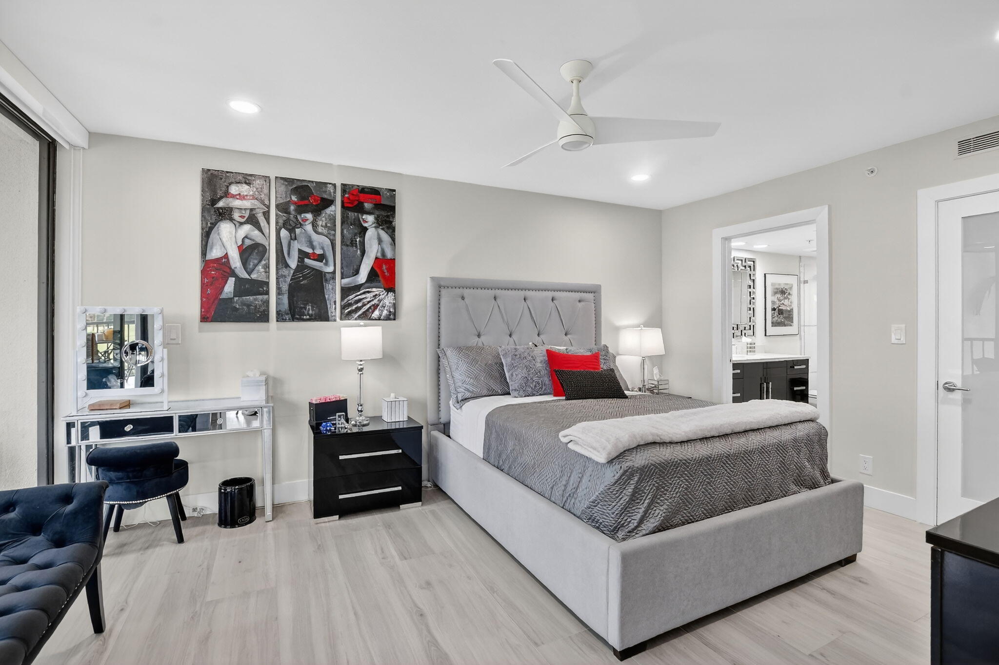 7802 Lakeside Boulevard, Unit 734 Boca Raton, FL 33434 - Photo 14 of 34 a bedroom with a bed and a chandelier