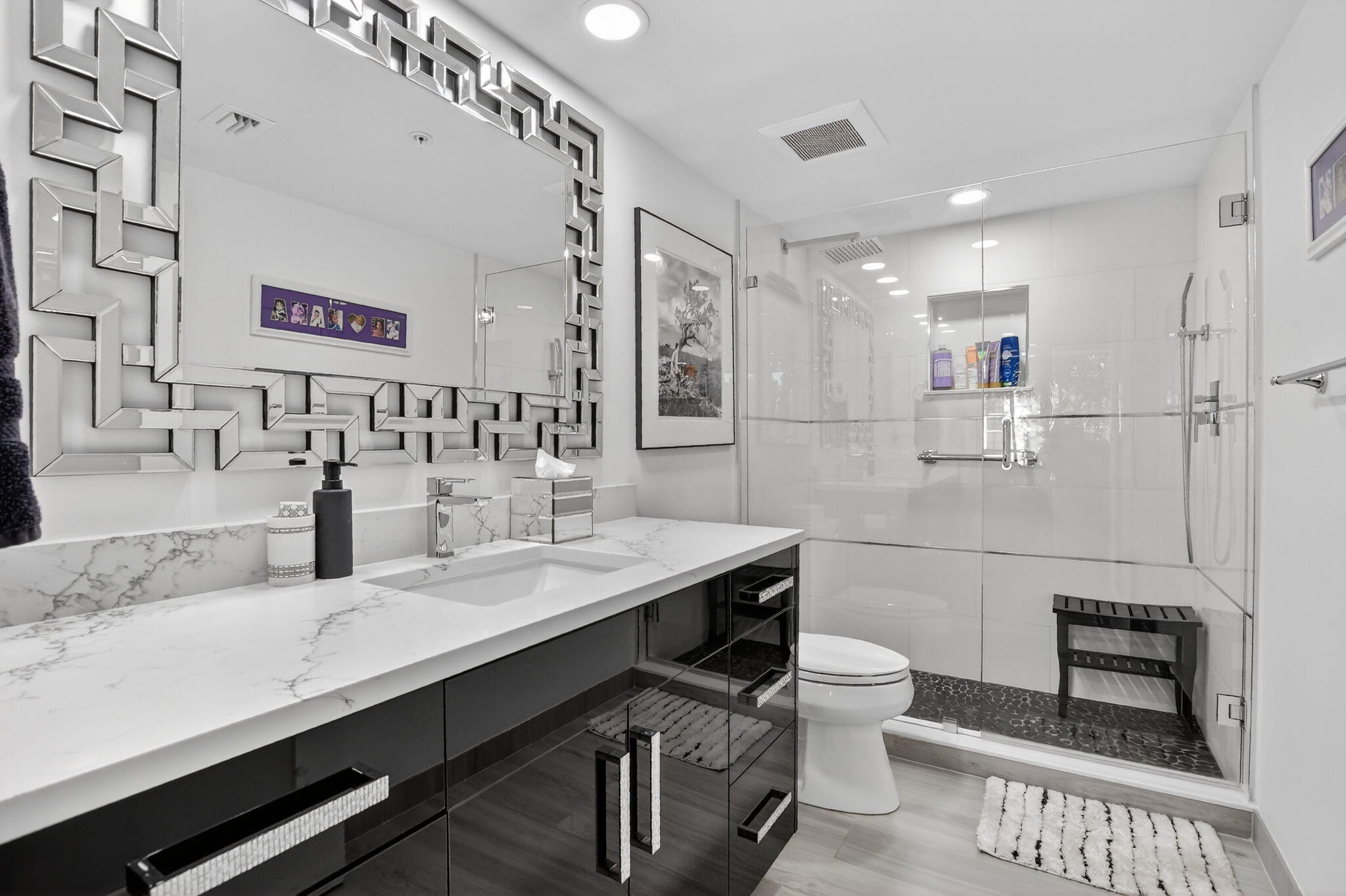 7802 Lakeside Boulevard, Unit 734 Boca Raton, FL 33434 - Photo 17 of 34 a bathroom with a sink a toilet a mirror and shower