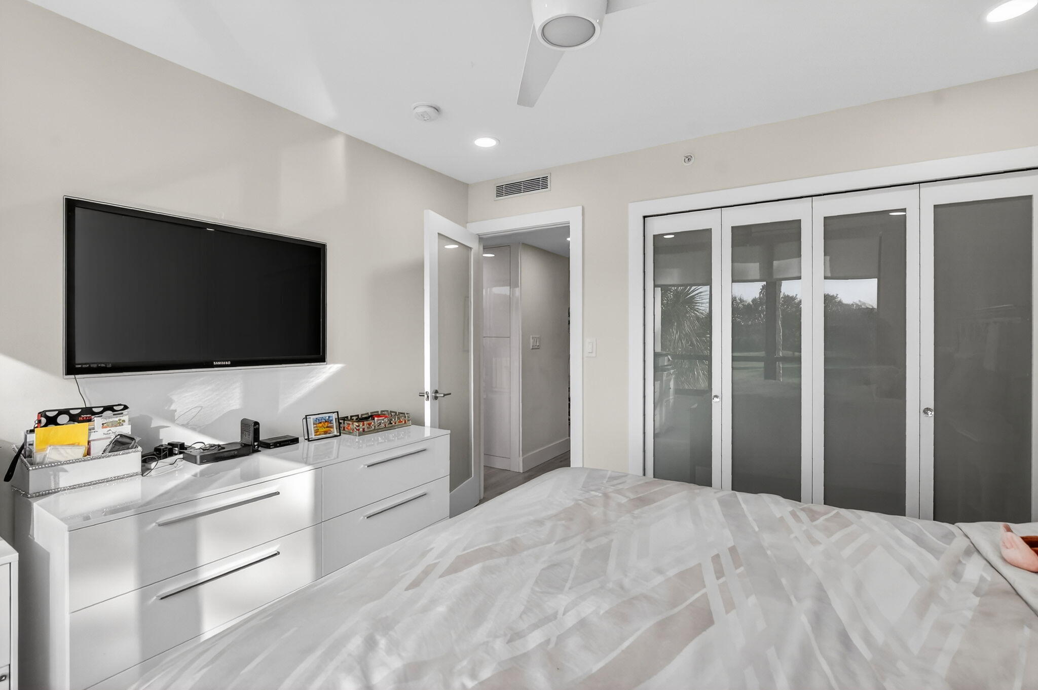 7802 Lakeside Boulevard, Unit 734 Boca Raton, FL 33434 - Photo 21 of 34 a bedroom with a bed and a flat screen tv