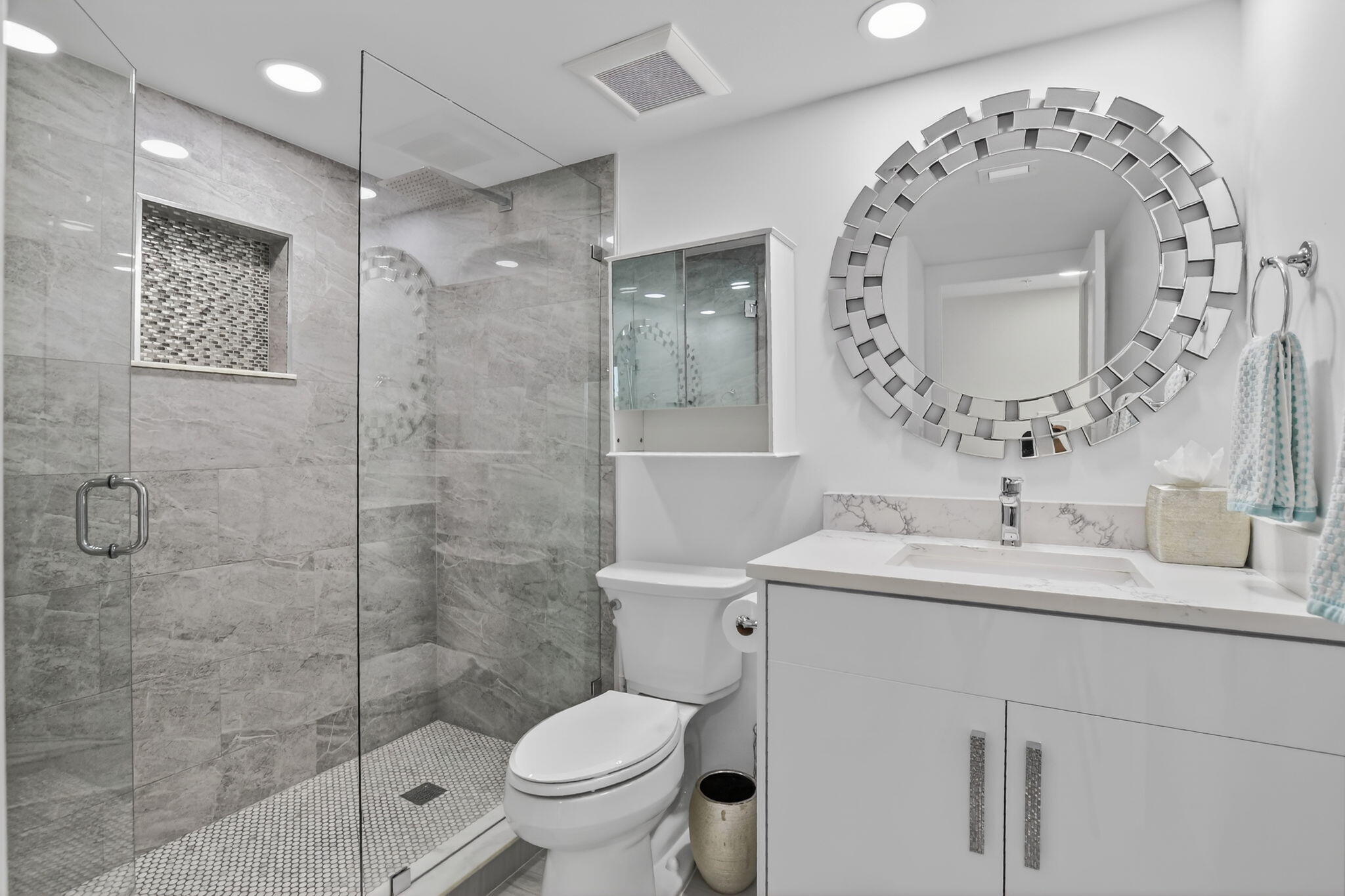 7802 Lakeside Boulevard, Unit 734 Boca Raton, FL 33434 - Photo 22 of 34 a bathroom with a toilet sink and mirror