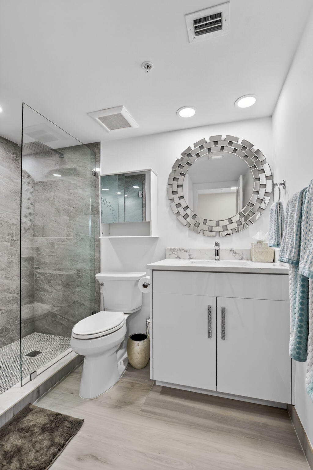 7802 Lakeside Boulevard, Unit 734 Boca Raton, FL 33434 - Photo 23 of 34 a bathroom with a sink toilet and shower