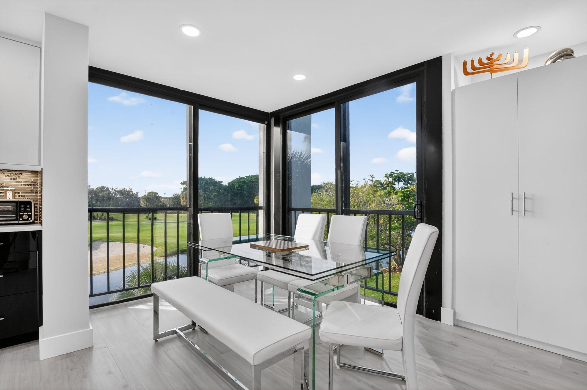 7802 Lakeside Boulevard, Unit 734 Boca Raton, FL 33434 - Photo 8 of 34 a living room with furniture tv and large windows