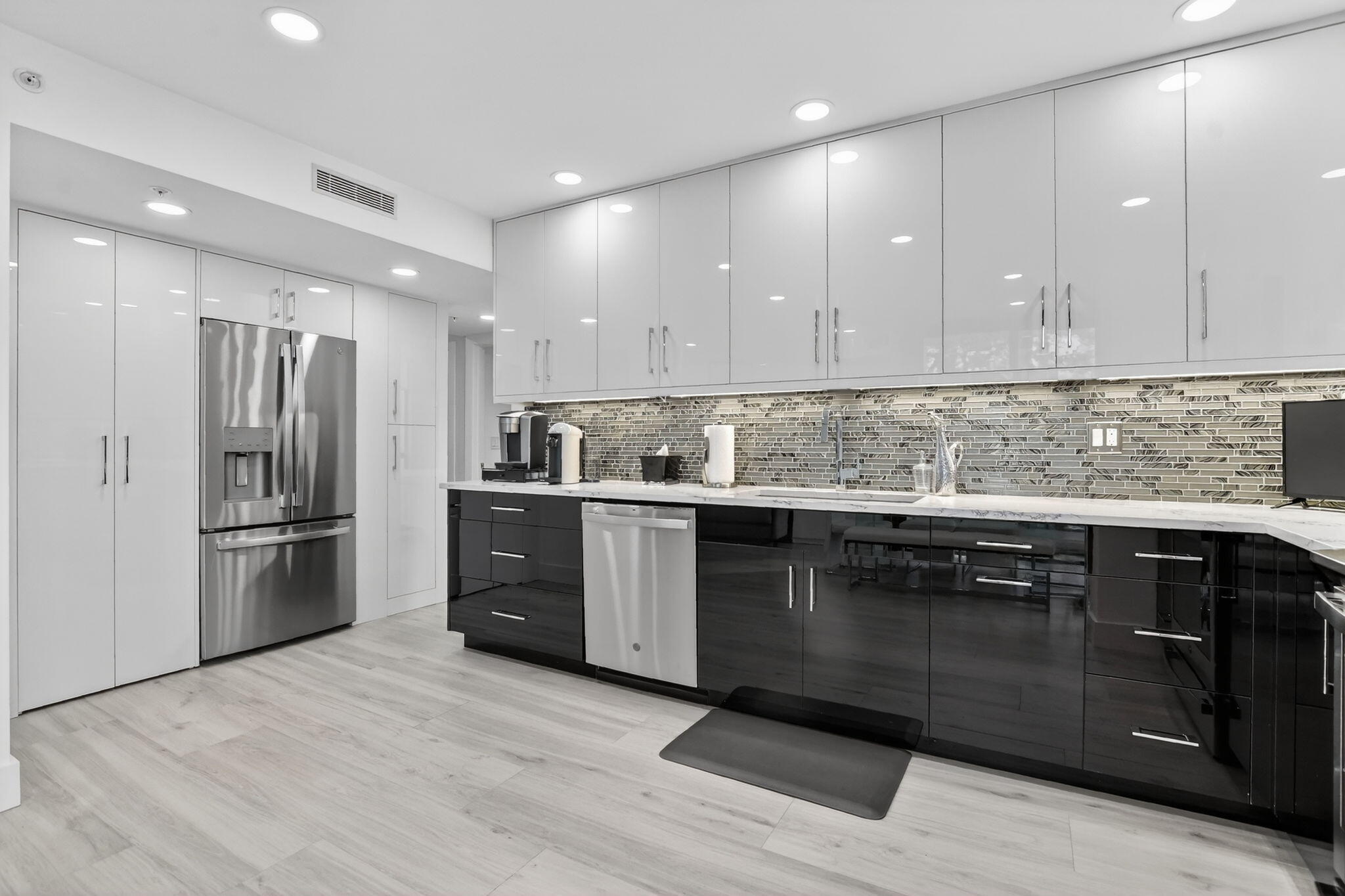 7802 Lakeside Boulevard, Unit 734 Boca Raton, FL 33434 - Photo 10 of 34 a kitchen with stainless steel appliances granite countertop a refrigerator and a sink