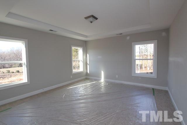 6204 Cotter Ridge Court Raleigh, NC 27603 - Photo 11 of 21 a view of an empty room with wooden floor and a window
