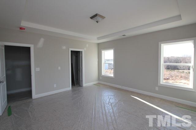 6204 Cotter Ridge Court Raleigh, NC 27603 - Photo 12 of 21 a view of an empty room with wooden floor and a window