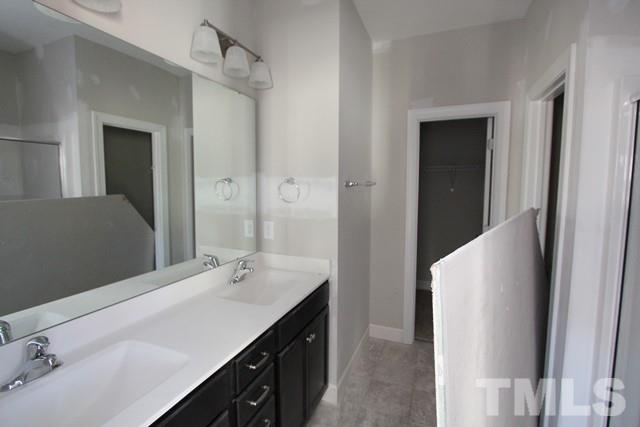 6204 Cotter Ridge Court Raleigh, NC 27603 - Photo 13 of 21 a bathroom with a double vanity sink and a mirror