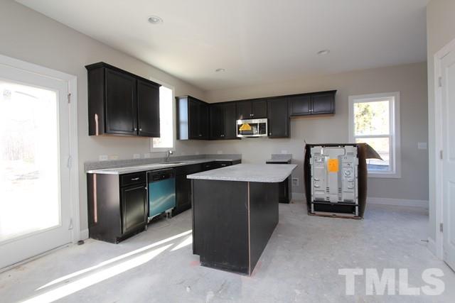6204 Cotter Ridge Court Raleigh, NC 27603 - Photo 3 of 21 a kitchen with stainless steel appliances granite countertop a stove and a sink