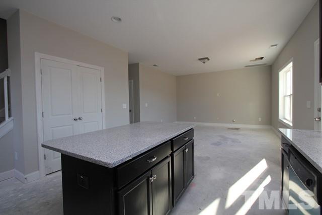 6204 Cotter Ridge Court Raleigh, NC 27603 - Photo 4 of 21 a kitchen with a stove and a hallway