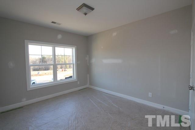 6204 Cotter Ridge Court Raleigh, NC 27603 - Photo 8 of 21 an empty room with a window