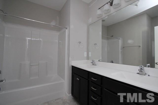 6204 Cotter Ridge Court Raleigh, NC 27603 - Photo 10 of 21 a bathroom with a double vanity sink and a mirror