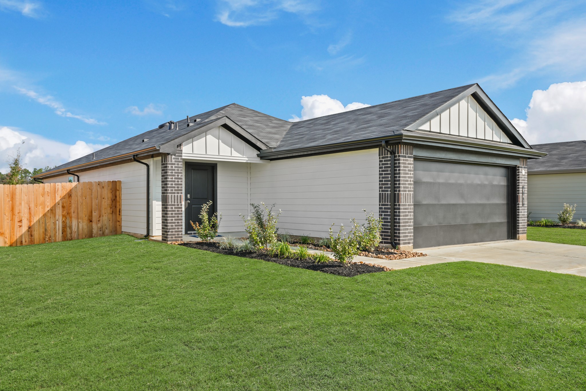 941 Sutherland Falls Street Conroe, TX 77303 - Photo 2 of 24 a front view of a house with a yard and garage