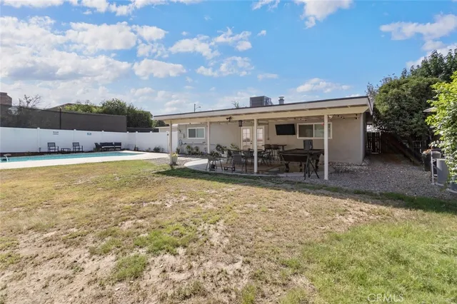 a view of a house with backyard porch and sitting area