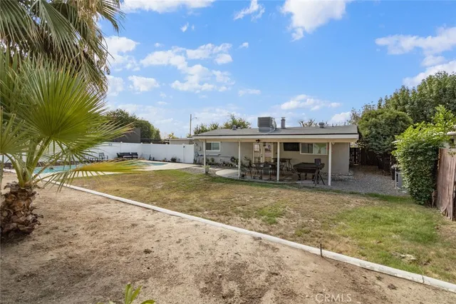 a view of house with outdoor space and swimming pool