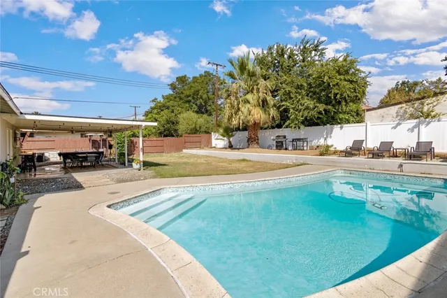 a view of a swimming pool with a patio