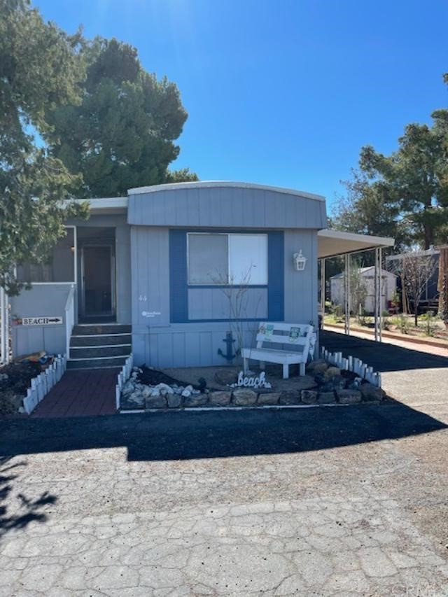 10200 Johnson Road, Unit 44 Phelan, CA 92371 - Photo 1 of 29 a front view of a house with a yard