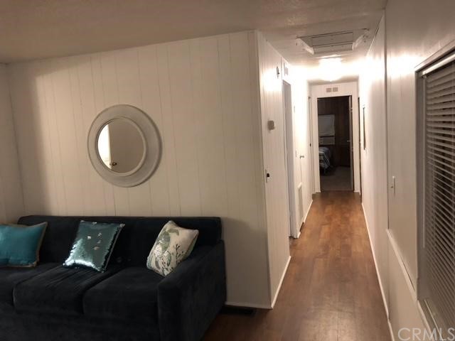 10200 Johnson Road, Unit 44 Phelan, CA 92371 - Photo 11 of 29 a living room with a couch and a floor to ceiling window