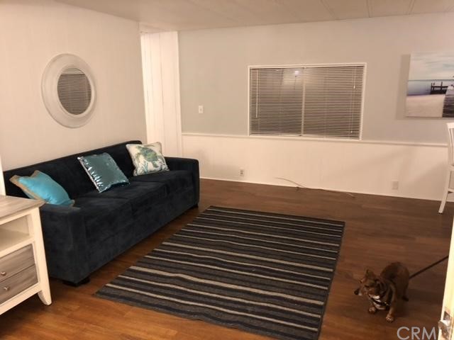 10200 Johnson Road, Unit 44 Phelan, CA 92371 - Photo 12 of 29 a living room with furniture and a wooden floor