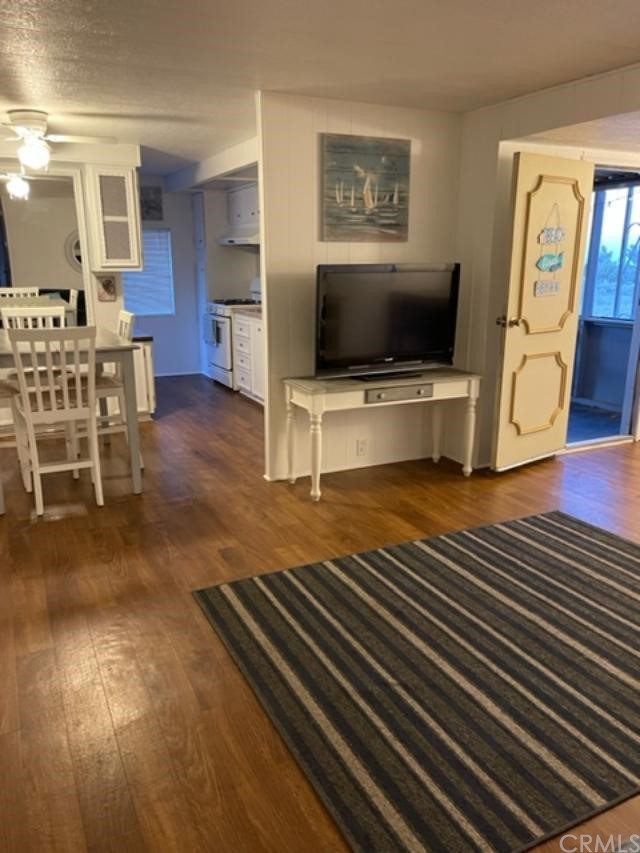 10200 Johnson Road, Unit 44 Phelan, CA 92371 - Photo 14 of 29 a living room with furniture and a flat screen tv