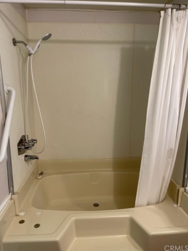 10200 Johnson Road, Unit 44 Phelan, CA 92371 - Photo 19 of 29 a bathroom with a tub and a shower