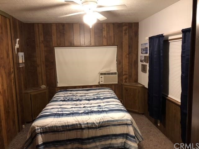 10200 Johnson Road, Unit 44 Phelan, CA 92371 - Photo 20 of 29 a bedroom with a bed and cabinets