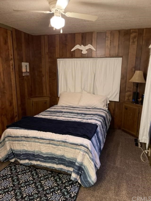 10200 Johnson Road, Unit 44 Phelan, CA 92371 - Photo 22 of 29 a bedroom with a bed and a chandelier