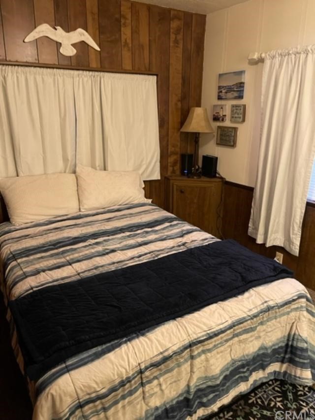 10200 Johnson Road, Unit 44 Phelan, CA 92371 - Photo 23 of 29 a bedroom with a bed and a window