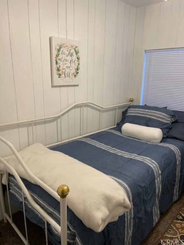 10200 Johnson Road, Unit 44 Phelan, CA 92371 - Photo 24 of 29 a bedroom with a bed and a table