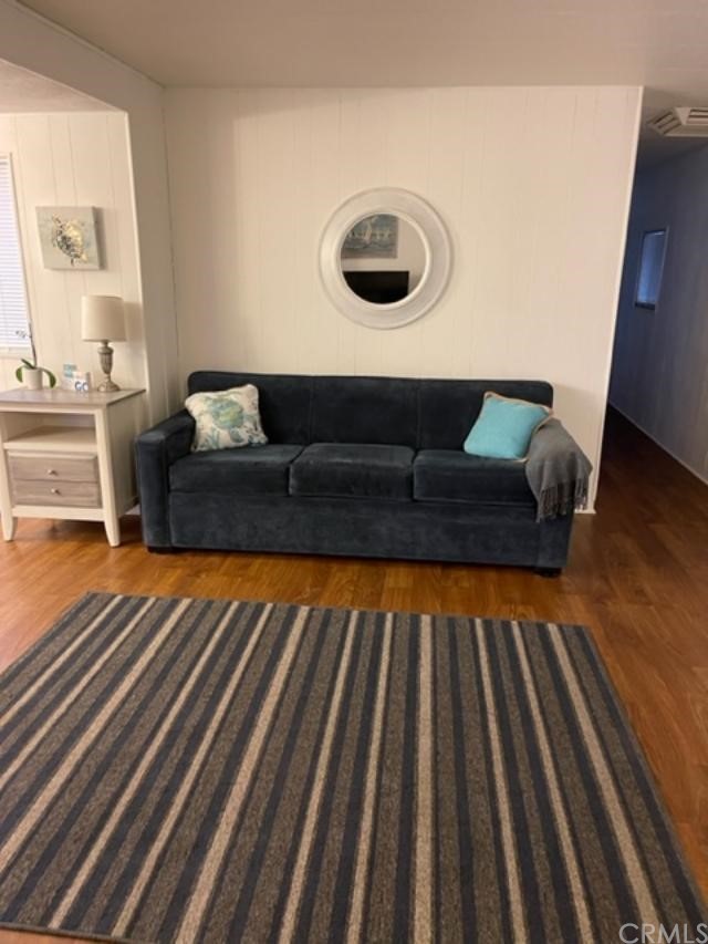 10200 Johnson Road, Unit 44 Phelan, CA 92371 - Photo 10 of 29 a living room with a couch and a rug