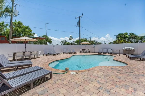 a swimming pool with outdoor seating