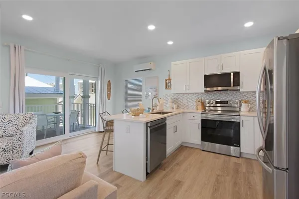 a view of kitchen with refrigerator stove dining table and chairs