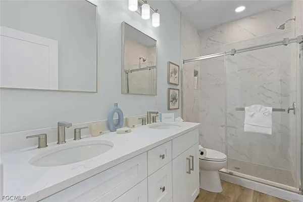 a spacious bedroom with a bed and a chandelier