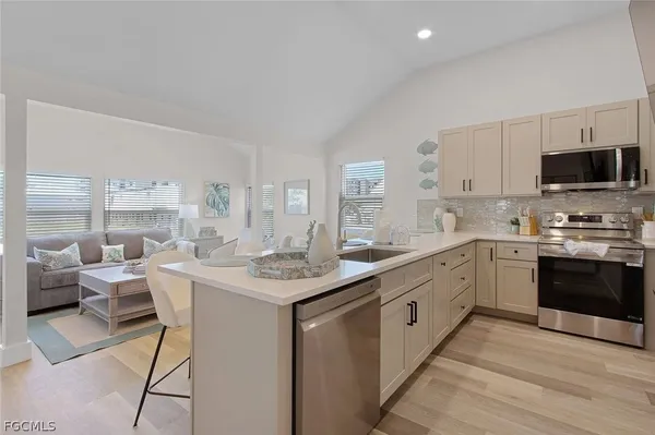 a kitchen with a sink and a stove top oven