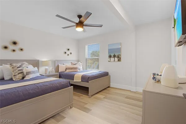 a bedroom with two beds and painting on the wall