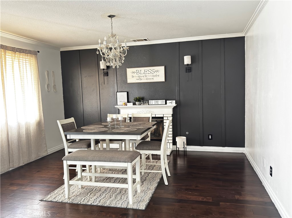 3807 Seattle Street Hemet, CA 92545 - Photo 12 of 37 a view of a dining room with furniture wooden floor and chandelier