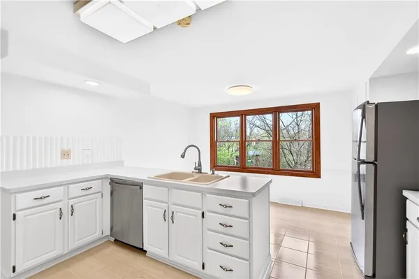 a kitchen with a sink stove and refrigerator