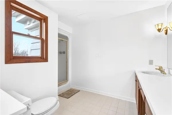 a bathroom with a sink vanity mirror and toilet