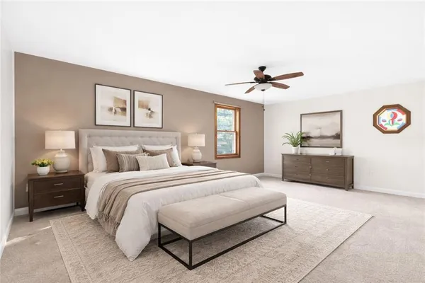 a spacious bedroom with a bed a dresser and a chandelier