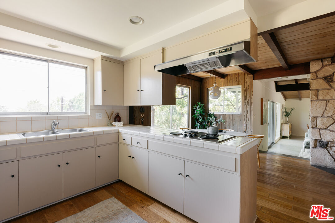 580 Cocopan Drive Altadena, CA 91001 - Photo 11 of 29 a view of center island wooden floor and cabinets